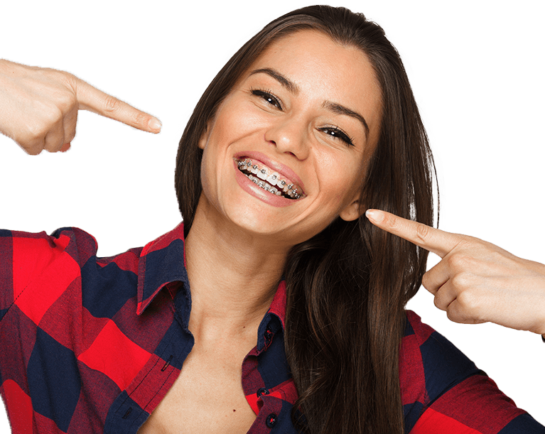 Young woman pointing to her smile with traditional braces