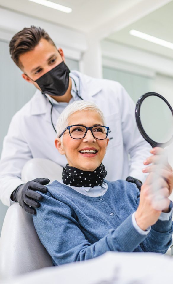 A dentist checking a senior dental patient