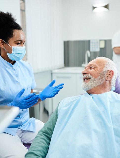 A dentist talking to her patient about all-on-4 implant candidacy