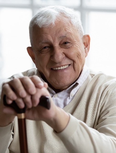 An older man happy with his all-on-4 implants