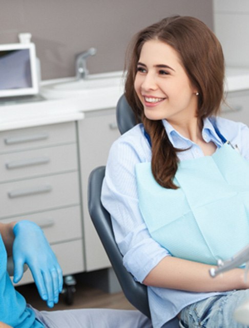 a dentist explaining the cost of traditional braces in Tucson