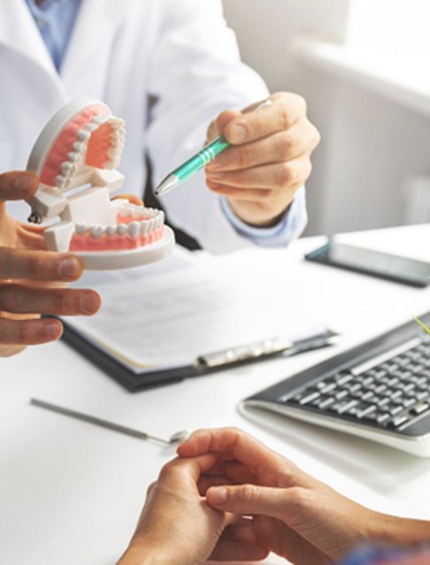 : a dentist explaining the cost of traditional braces in Tucson