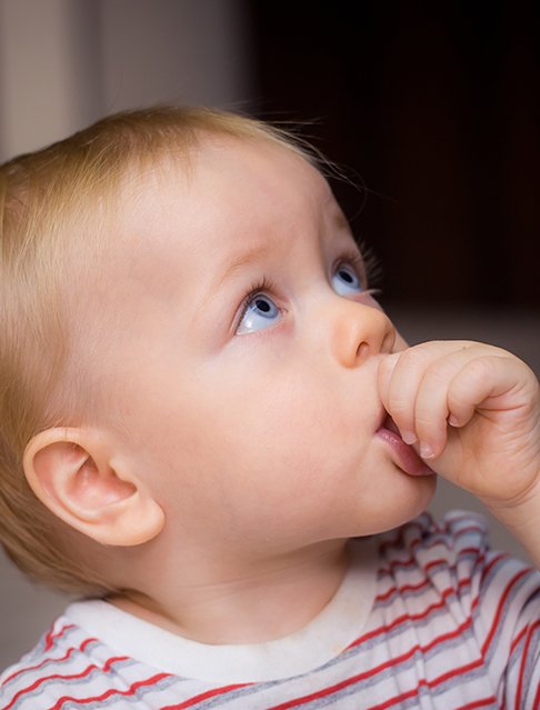 Young child sucking his thumb