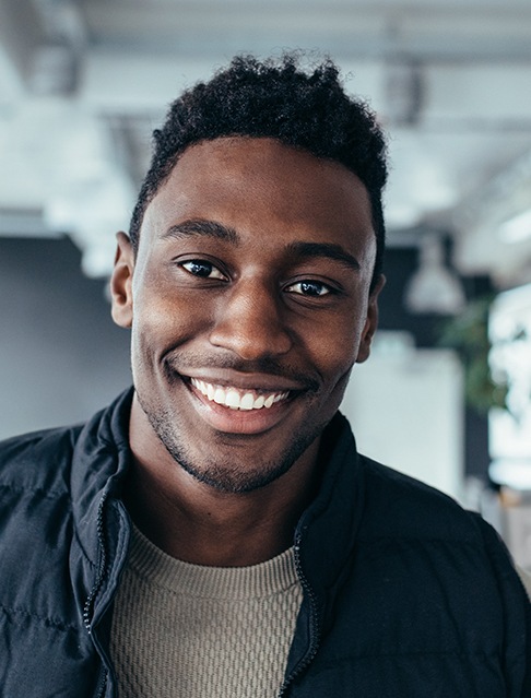 Man with bright smile after KoR teeth whitening