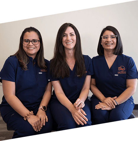 Doctor Fitzgerald smiling with two Marana dental team members