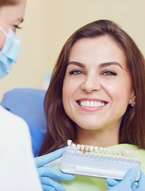 Woman smiling with dental crown in Tucson