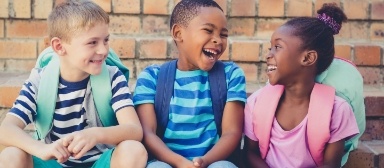 Three kids laughing together after children's dentistry visit