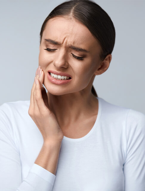 Man with a toothache in Marana touching his face