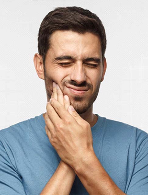 Man with a toothache in Marana touching his face