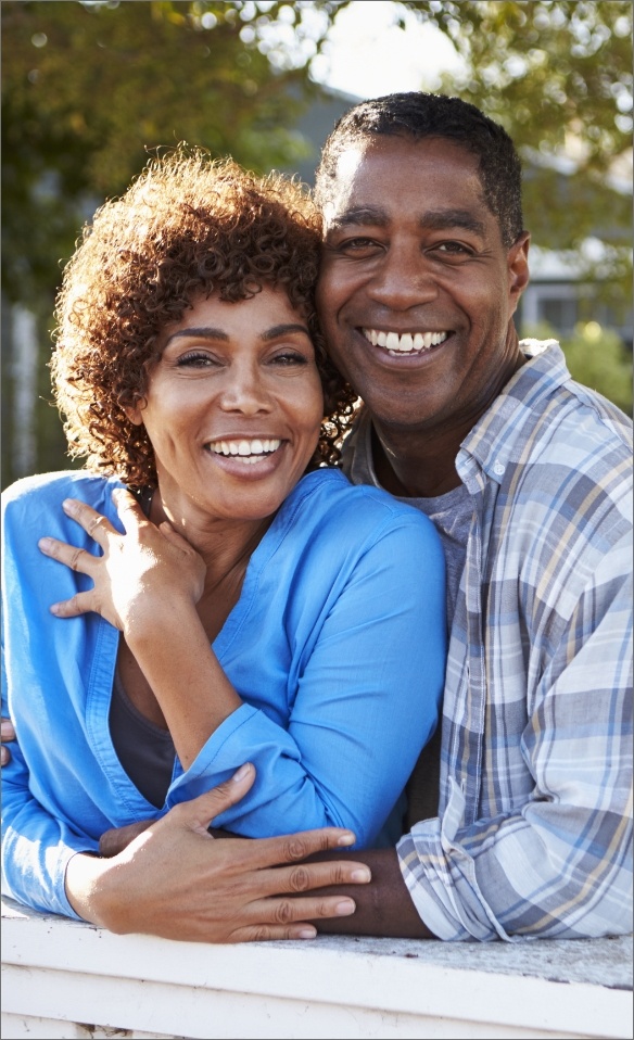 Man and woman smiling after receiving dental implants in Marana, AZ