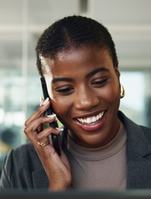 Closeup of woman smiling while talking on phone