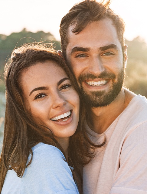 Man and woman sharing smiles after Smile Stream I P appliance treatment