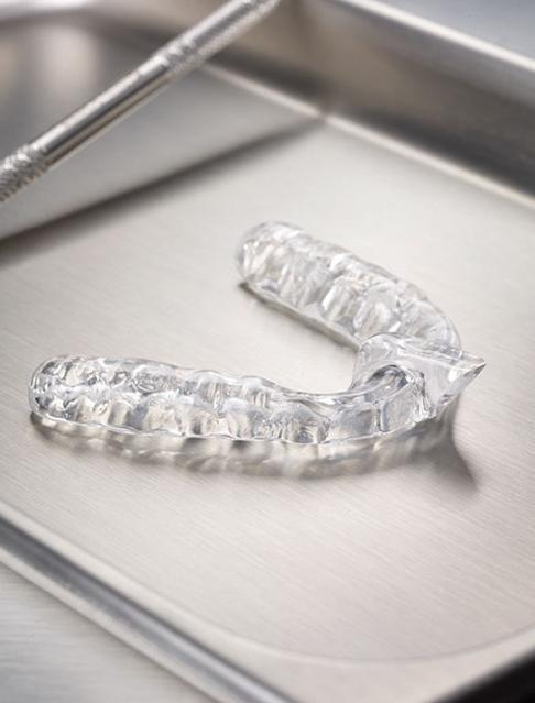 Clear nightguard for bruxism on metal tray