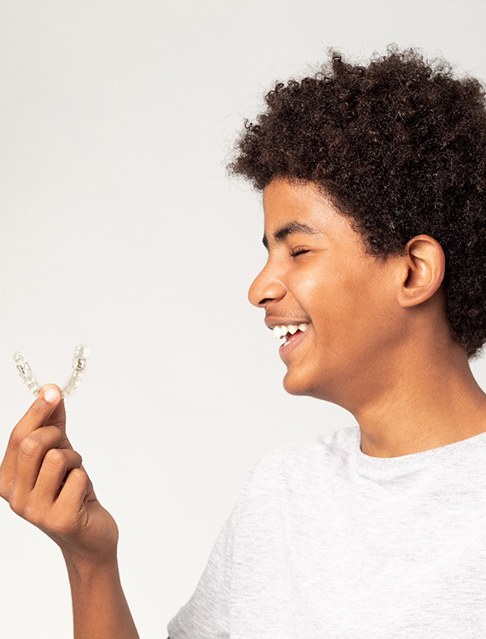 young man holding Spark Clear Aligner