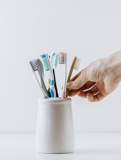 Taking toothbrush out of a toothbrush holder