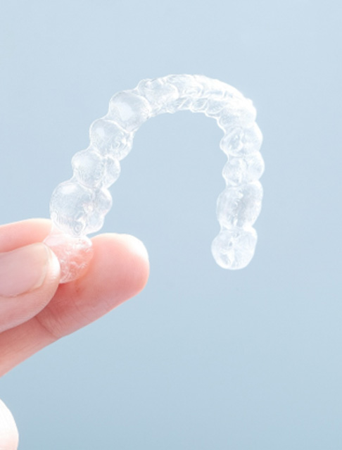 Patient holding clear aligner