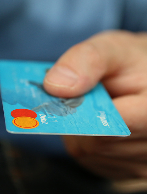 Man’s hand holding debit card