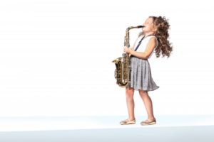 young girl playing the saxophone 