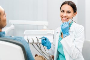 a woman dentist proudly serving her patient