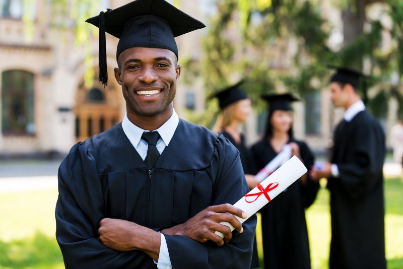 young graduate holding a diploma