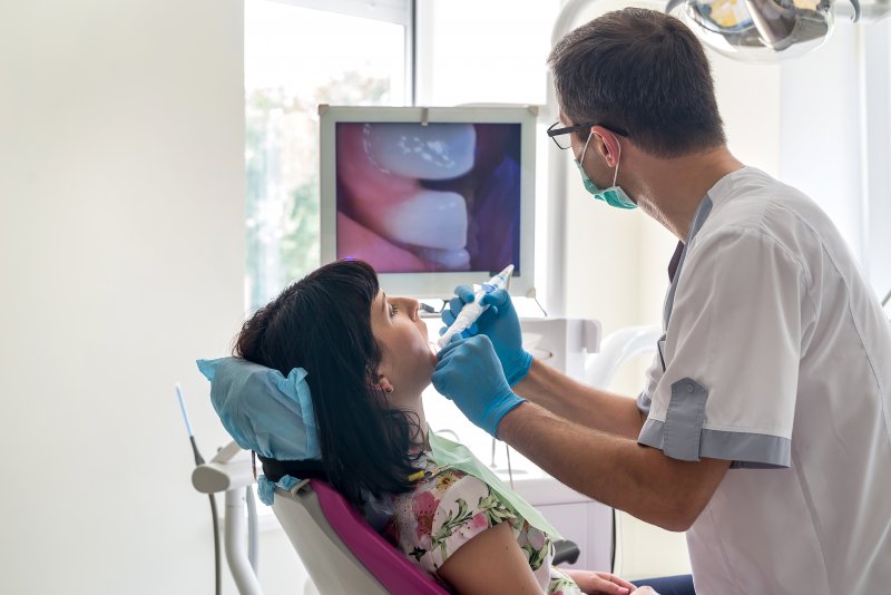 A dentist using an intraoral camera