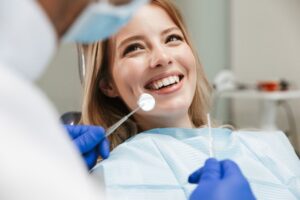 Woman smiling at dentist appointment.